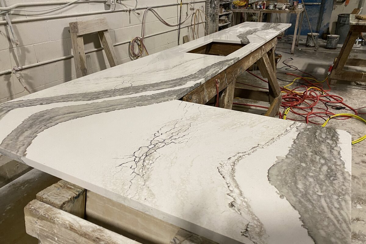 Marble countertop being fabricated in workshop on sawhorses