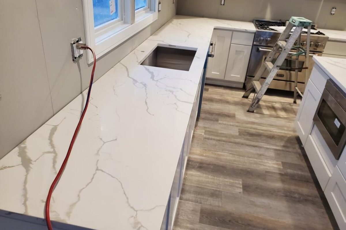 White Calacatta quartz countertop installation in progress