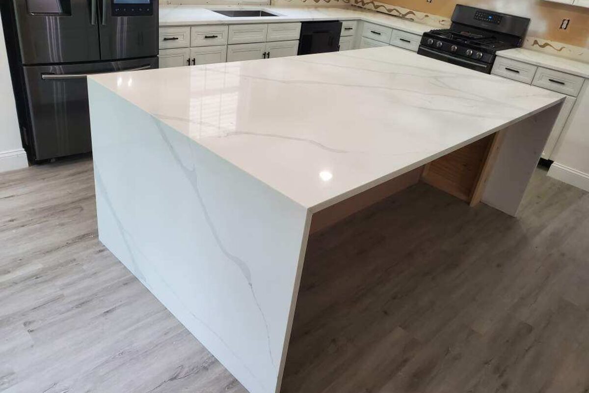 Finished waterfall edge kitchen island with Calacatta marble